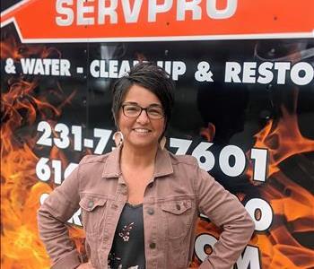 Colleen standing next to fire/water SERVPRO trailer