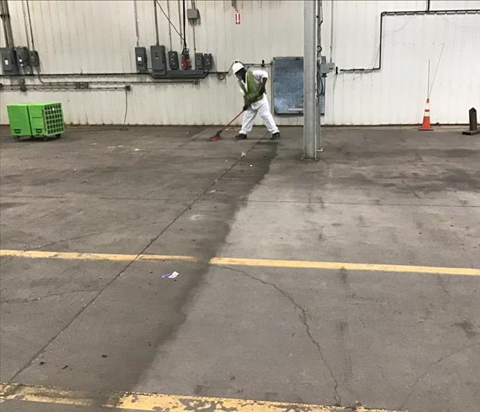 SERVPRO technician cleaning up commercial flooring after a fire